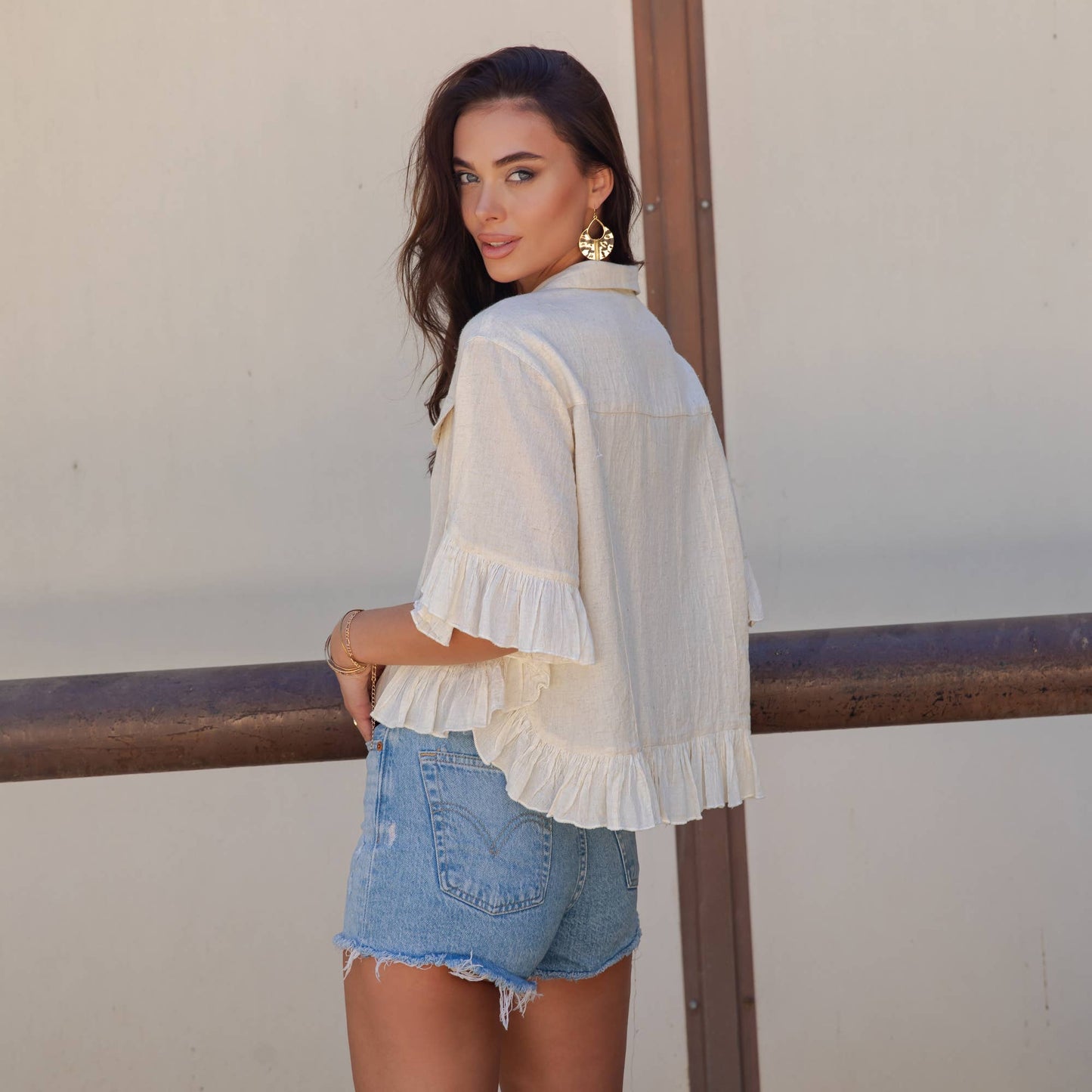 Distressed Denim Crop Jacket with Ruffled Hem