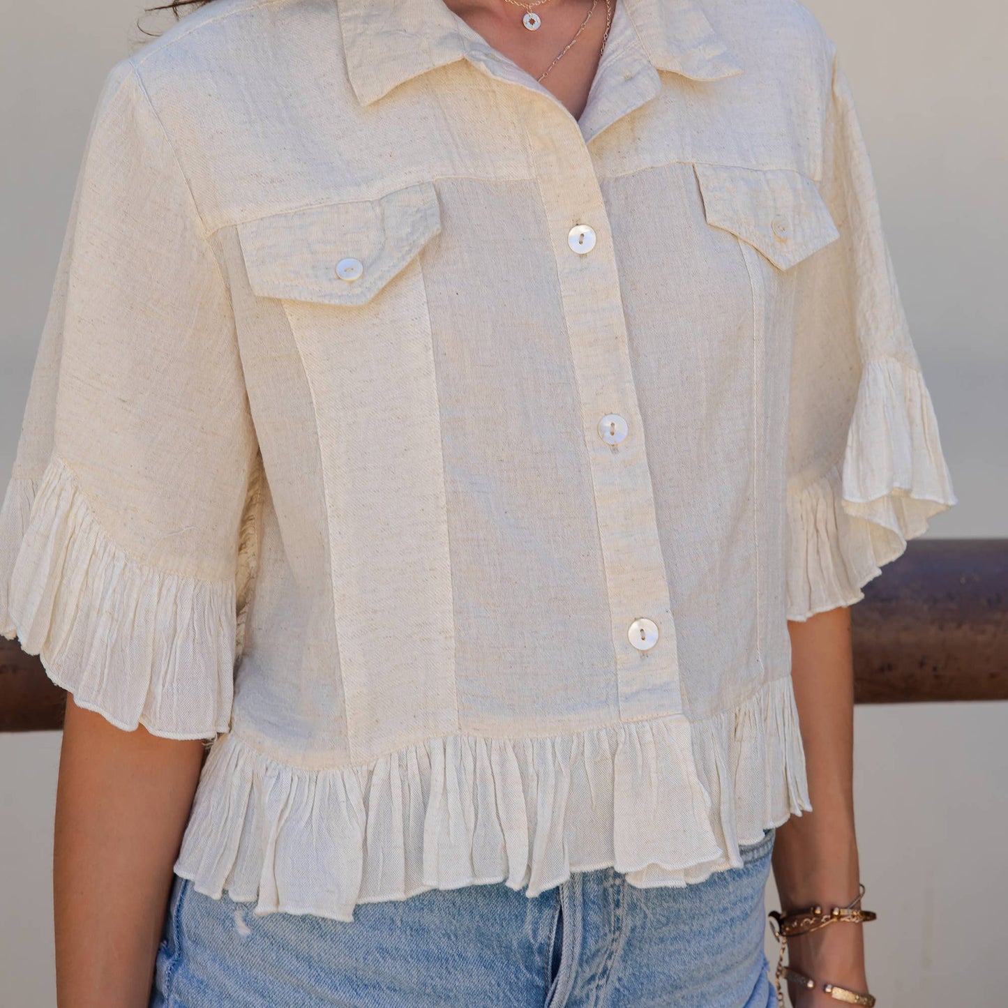 Distressed Denim Crop Jacket with Ruffled Hem